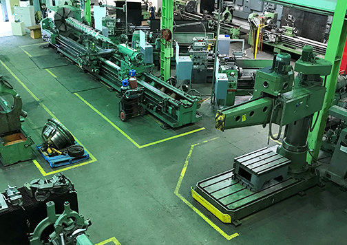 Overhead view of the machining workshop floor, featuring equipment