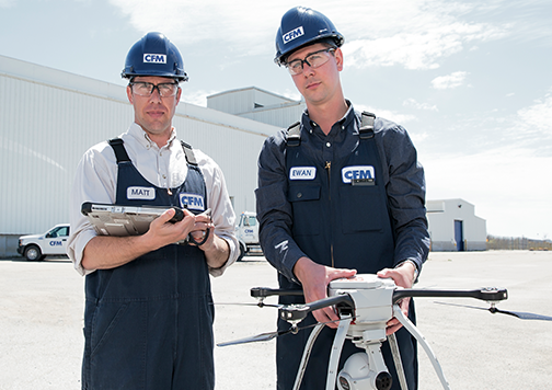 Two drone operators posing with their drone